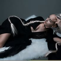 Portrait in a black costume with contrasting light trim